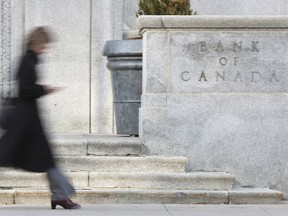 This file photo taken on April 12, 2011 shows a woman walking past the Bank of Canada building in Ottawa.