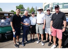 Cal 0817 Flames tournament 7 Pictured, from left, at the  25th annual Calgary Flames Alumni Masters Tournament held at Heritage Pointe are Calgary Flames' Ziad Mehio, Willow Park Wines & Spirits' Wayne Henuset, Calgary Flames owner Jeff McCaig, Ken King, Rollie Cyr and Trent Anderson. The tournament raised $100,000 for Cerebral Palsy Kids and Families.