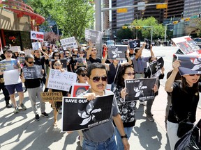Over 100 Calgarians came out for the STAND WITH HONG KONG rally which took place from Chinatown to the Chinese Consulate in Calgary on Sunday, August 4, 2019. Darren Makowichuk/Postmedia