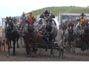 Kurt Bensmiller ris in the lead on the final stretch during the Dash for Cash $50,000 heat at the WPCA World Championships at Century Downs Racetrack & Casino. Bensmiller won the event and will take home $25,000. The rest will be spilt between the other three chuckwagon drivers. Sunday, August 25, 2019. Brendan Miller/Postmedia