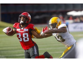 Calgary Stampeders Terry Williams takes a nasty shove from a Edmonton Eskimos player in first half CFL action at McMahon stadium in Calgary on Saturday, August 3, 2019. Darren Makowichuk/Postmedia