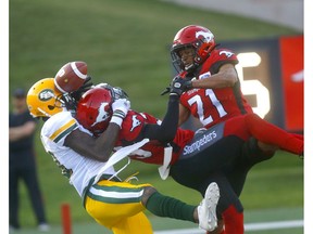 Calgary Stampeders Jamar Wall and Raheem Wilson battle Edmonton Eskimos Kevin Elliott to secure the win on the last play in second half CFL action at McMahon stadium in Calgary on Saturday, August 3, 2019. Darren Makowichuk/Postmedia