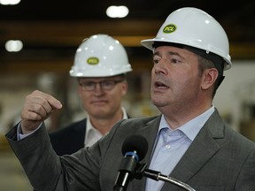 Associate Minister of Red Tape Reduction Grant Hunter, left, appears with Premier Jason Kenney at the PCL fabrication facility in Nisku on May 29, 2019.