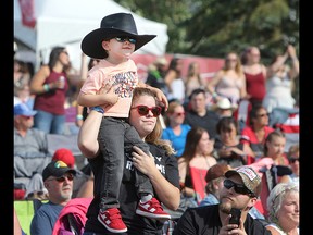 Music fans watch the Hunter Brothers perform on the second day of the Country Thunder music festival, held at Prairie Winds Park in Calgary Saturday, August 17, 2019. Dean Pilling/Postmedia