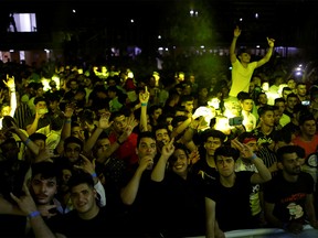 Young people dance and cheer as they attend electronic music concert with western tunes at closed Hall in Shaab Stadium for the first time in Baghdad, Iraq August 16, 2019. Picture taken August 16, 2019  REUTERS/Thaier Al-Sudani ORG XMIT: HFSGGG-BAG502