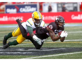 Calgary Stampeders, Kamar Jorden makes a catch with Edmonton Eskimos, C. Mulumba-Tshimanga on him in first half action during the Labour Day Classic at McMahon stadium in Calgary on Monday September 3, 2018. Darren Makowichuk/Postmedia