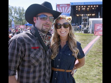 Music fans Greg Norgon and Kimberley Peters enjoy the sunshine as country duo Leaving Thomas performs on the third day of the Country Thunder music festival, held at Prairie Winds Park in Calgary Saturday, August 17, 2019. Dean Pilling/Postmedia