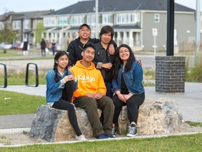 CClaro and Jesse Pasamanero with their children, Joana, 18, Jiego, 16, and  Maxine, 12, in front of their Mattamy Town Home in Cityscape.