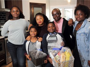 The Onuoha family celebrate taking possession of their new home in Redstone, in northeast Calgary.