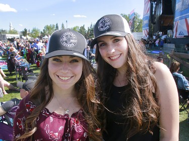 Rosie Paspalini and Cadence Fuller enjoy the sunshine as Roots and Boots perform on the third day of the Country Thunder music festival, held at Prairie Winds Park in Calgary Saturday, August 17, 2019. Dean Pilling/Postmedia