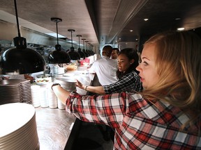 Servers work the busy lunch hour at a Calgary Earls restaurant in this 2016 file photo.