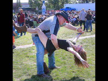 Country music fans Elaine Muller and Steve La Chavelle dance on the second day of the Country Thunder music festival, held at Prairie Winds Park in Calgary Saturday, August 17, 2019. Dean Pilling/Postmedia