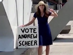 A woman holding a sign supporting Andrew Scheer went on a racist rant outside Toronto City Hall.