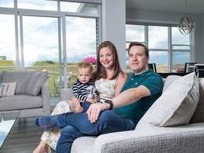 Julien and Melanie Villefranche and their 15-month-old son Henry in their home in Crestmont West.