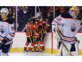 The Calgary Flames celebrate Glenn Gawdin's goal against Edmonton Oilers during the Battle of Alberta prospects game at Scotiabank Saddledome in Calgary on Tuesday. Photo by Azin Ghaffari/Postmedia.