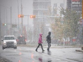 Calgarians endure snowfall along 85th St. S.W. in Calgary on Friday, Sept. 27, 2019.