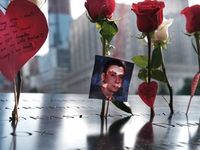 NEW YORK, NEW YORK - SEPTEMBER 11: A picture is placed in a name along the National September 11 Memorial during a morning commemoration ceremony for the victims of the terrorist attacks Eighteen years after the day on September 11, 2019 in New York City. Throughout the country services are being held to remember the 2,977 people who were killed in New York, the Pentagon and in a field in rural Pennsylvania.