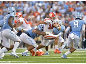 Aaron Crawford #92 of the North Carolina Tar Heels wraps up Trevor Lawrence #16 of the Clemson Tigers during the second half of their game at Kenan Stadium on September 28, 2019, in Chapel Hill, North Carolina. Clemson won 21-20. Grant Halverson/Getty Images