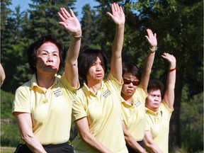Members of the Chao Chow Community Society practise tai chi in Bowness Park. From tai chi to Olympic training, participants are all part of Calgary's active economy, which has huge potential, say columnists.