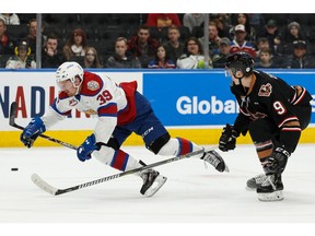 Edmonton Oil Kings' Andrew Fyten (39) is tripped up by Calgary Hitmen's Egor Zamula (9) during the second period of a WHL hockey game at Rogers Place in Edmonton, on Saturday, March 16, 2019. Photo by Ian Kucerak/Postmedia