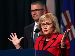 Former Saskatchewan finance minister Janice MacKinnon speaks on the report she chaired on the state of the province's finances at the McDougall Centre in Calgary on Tuesday September 3, 2019. Finance Minister Travis Toews listens in the background. Gavin Young/Postmedia