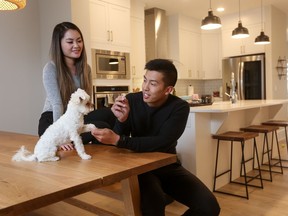 Kirstie Du and Raymond Yip, with their dog Kumo, bought a house by Daytona Homes in Livingston.