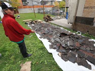 Alex Clarke shows shingles separated out for recycling at a garage demolition in Bridgeland. He demolished the garage carefully by hand with the goal of recycling as much of the material as possible. The demolition was part of a larger project renovating the property for the RCCG Christ Embassy church. Clark hopes the project which also employed homeless workers from the Calgary DropIn Centre will be the first of many to show how the homeless community can work together on eco-friendly community construction projects. 
Gavin Young/Postmedia