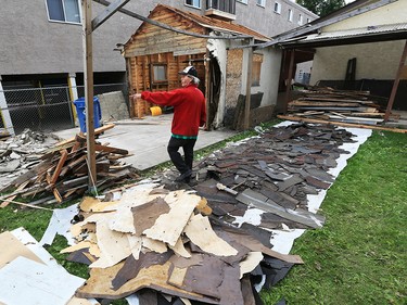 Alex Clarke shows materials separated out for recycling, reuse or disposal at a garage demolition in Bridgeland. He demolished the garage carefully by hand with the goal of recycling as much of the material as possible. The demolition was part of a larger project renovating the property for the RCCG Christ Embassy church. Clark hopes the project which also employed homeless workers from the Calgary DropIn Centre will be the first of many to show how the homeless community can work together on eco-friendly community construction projects. 
Gavin Young/Postmedia