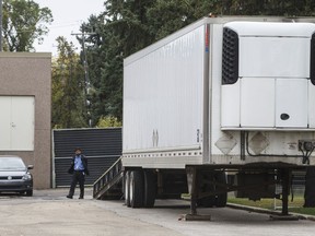 A security guard keeps an eye on a trailer where where bodies were reportedly stored in rented trailer as medical examiner copes with space shortage in Edmonton Alta, on Wednesday September 11, 2019. The Alberta government is investigating after video surfaced showing the medical examiner's office using a truck trailer to store dead bodies, with one corpse being roughly hauled and handled.