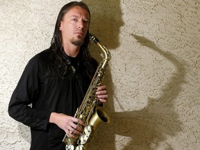 Busker Kieran Kirchner with his new sax after he was attacked and had his old sax stolen after performing in downtown Calgary. Darren Makowichuk/Postmedia