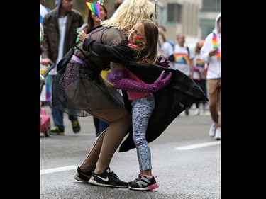 A young spectator receives a mid parade hug as Calgarians  celebrated pride week with the Calgary Pride parade through downtown Calgary on Sunday September 1, 2019.