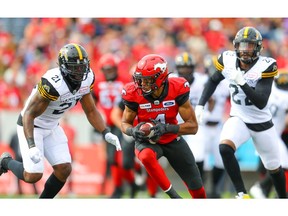Calgary Stampeders' Eric Rogers makes a catch in front of Simoni Lawrence and Justin Tuggle of the Hamilton Tiger-Cats during CFL football in Calgary on Saturday, September 14, 2019. Al Charest/Postmedia
