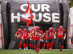 Eric Mezzalira of the Calgary Stampeders runs onto the field during player introductions before facing the Hamilton Tiger-Cats in the season opener in CFL football on Saturday, June 16, 2018. Al Charest/Postmedia