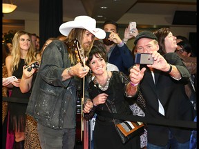 Billy Rae Cyrus arrives on the red carpet at the Canadian Country Music Awards at the Saddledome in Calgary Sunday. Photo by Jim Wells/Postmedia.