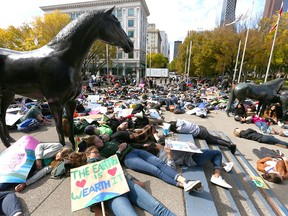 Climate change supporters stage a "die-in" in front of Calgary city hall on Friday, September 20, 2019.