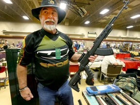 Collector/ gun enthusiast Steve Tristram holds up a SKS rifle at "The Finest Little Gun Show in the West (Calgary)" at the Thorncliff Community Centre in northeast Calgary on Saturday, September 21, 2019. Jim Wells/Postmedia