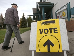People head in Kenilworth Community Hall for the federal election vote in Edmonton, Alberta on October 19, 2015.