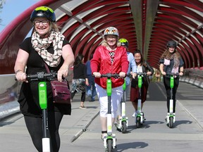 Calgarians enjoy a lunch hour ride on the new e-scooters that have become increasingly popular throughout the city Wednesday, September 4, 2019. Dean Pilling/Postmedia