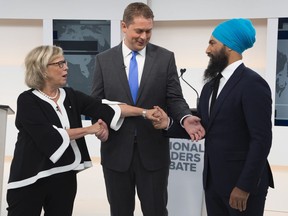 Green Party Leader Elizabeth May, left, Conservative Leader Andrew Scheer, centre, and NDP Leader Jagmeet Singh shake hands during the Maclean's/Citytv National Leaders Debate in Toronto on Thursday, Sept. 12, 2019.