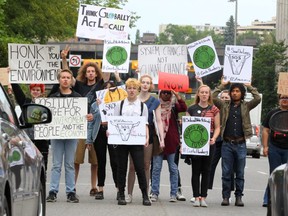 Calgary Students who have joined the international movement "Fridays For Future" to fight climate change and raise awareness are seen in the crosswalk of Macleod Tr. and 8th Ave. SW during a Red Light on Friday, August 23, 2019.