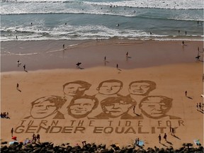 The faces of the G7 leaders are seen reproduced by local Basque sand artist Sam Dougados in the sand on a beach with a message on gender equality in Biarritz on the eve of the Biarritz G7 summit, France, August 23, 2019.