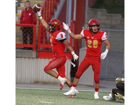 Dinos DB Nick Statz celebrates after an interception during Friday night's 24-10 victory over the Manitoba Bisons at McMahon Stadium. Photo by Brendan Miller/Postmedia.