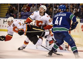 Sep 16, 2019; Victoria, British Columbia, CAN; Calgary Flames defenseman Michael Stone (26) collides with teamate  during the first period at Save-On-Foods Memorial Centre. Mandatory Credit: Anne-Marie Sorvin-USA TODAY Sports ORG XMIT: USATSI-406709