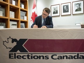 Chief Electoral Officer Stephane Perrault signs the writs of the 43rd general election during a photo opportunity in Gatineau, Que., Friday, Sept. 20, 2019.