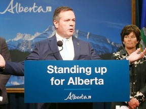 Alberta Premier Jason Kenney is joined by MInister of Justice and Solicitor General Doug Schweitzer (left, unseen) and Minister of Energy Sonya Savage in Calgary on Thursday, July 4.