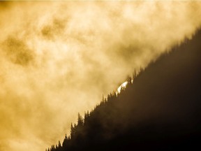 The sun peeks through a bank of fog hanging in the Cataract Creek valley along the Highwood River west of Eden Valley, Ab., on Tuesday, August 27, 2019. Mike Drew/Postmedia