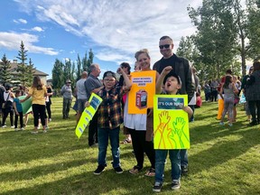 Nate and Nikki Pike rally with their sons, Noah, 8, and Newin, 7, who chant, "It's our turn," while holding signs at the demonstration for North Calgary High School in Coventry Hills on Sept. 15, 2019. Photo Stephanie Babych