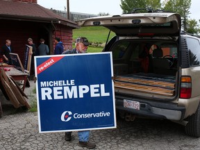 Volunteers for incumbent Calgary Nose Hill MP Michelle Rempel organize signs at her campaign headquarters on Wednesday, Sept. 11, 2019.
