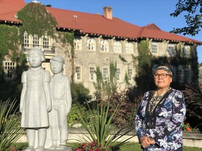 Margaret Teneese, archivist of the Ktunaxa Nation Council, stands in front of the former residential school which has been transformed into St. Eugene Golf Resort & Casino near Cranbrook, B.C.