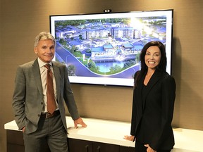 Ronmor Developments chairman Doug Porozni, with Dallas Wingerak, the firm's recently appointed chief executive, stand in front of a rendering of Ronmor's Sage Hill Quarter development. Supplied photo, for David Parker column. Sept. 19, 2019